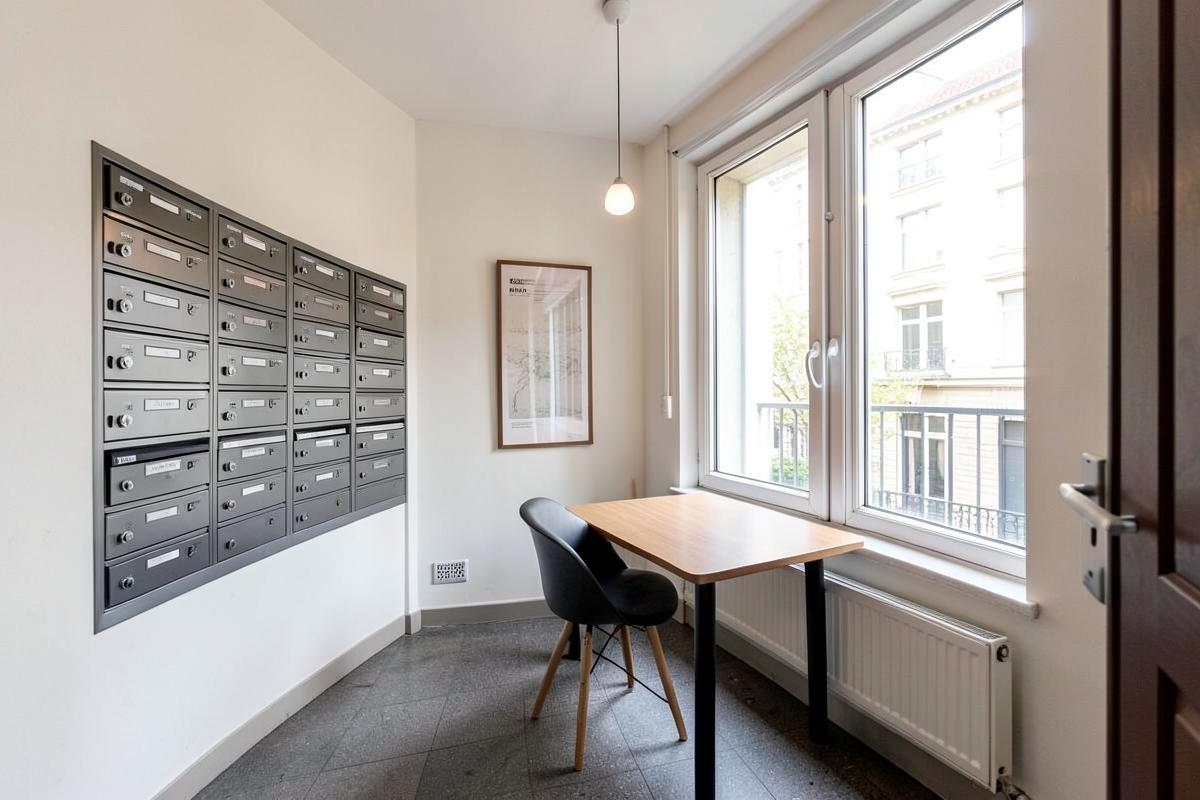 Hall d'immeuble bruxellois avec boîtes aux lettres de copropriété